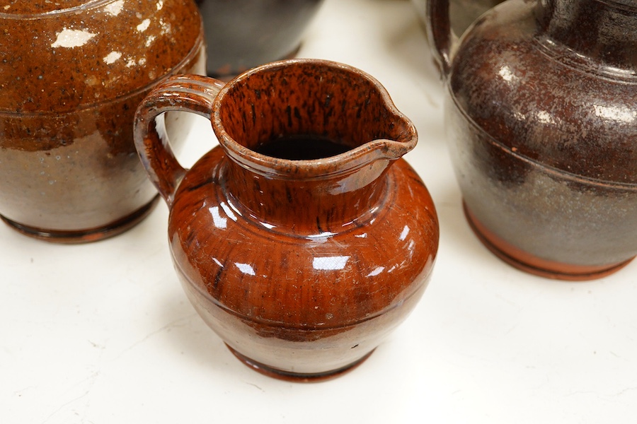 A group of stoneware glazed flagons and jugs, largest 29cm high. Condition - some chips